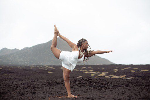 A woman is doing yoga in the desert